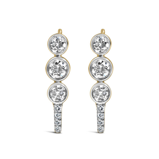 Close-up front view of a pair of yellow metal drop earrings featuring multiple round white gemstones in bezel settings along the front length.