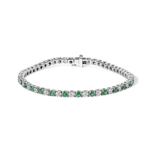 White metal bracelet with alternating round white and green gemstones set in prongs, shown flat at a slight angle.