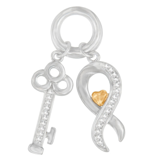 Close-up front view of a two-tone necklace pendant featuring a silver key with white gemstones in prong settings and a silver ribbon shape adorned with white gemstones and a small gold heart detail.