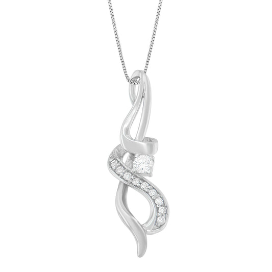 Front-facing close-up of a white metal necklace pendant with a flowing ribbon design, featuring a row of small round white gemstones in prong settings and one larger round white gemstone.