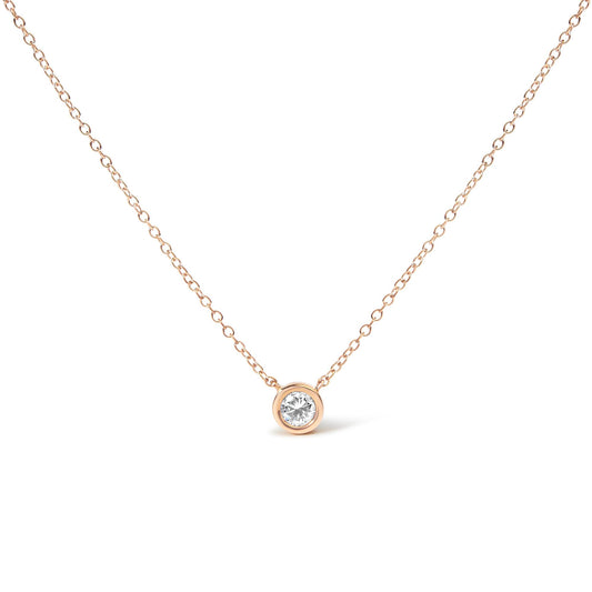Front view of a rose-colored necklace with a single round white gemstone in a bezel setting pendant.