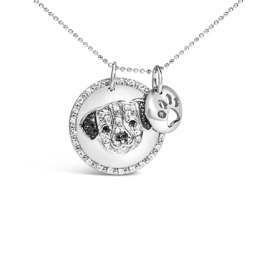 Close-up front angle of a white necklace with two circular pendants, one featuring a dog face adorned with white and black gemstones and the other a smaller disc with a paw print accented by a white gemstone.