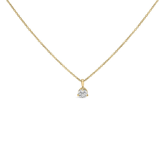 Front-facing shot of a yellow necklace with a round white gemstone in a three-prong setting pendant.