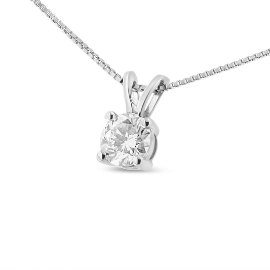Close-up angle of a white metal necklace featuring a round white gemstone in a four-prong setting.