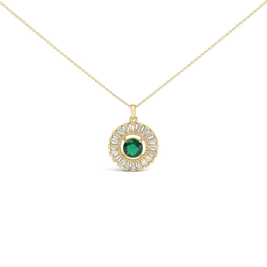 Close-up front view of a yellow metal necklace with a circular pendant featuring a round green gemstone in the center surrounded by baguette-shaped white gemstones in a channel setting.