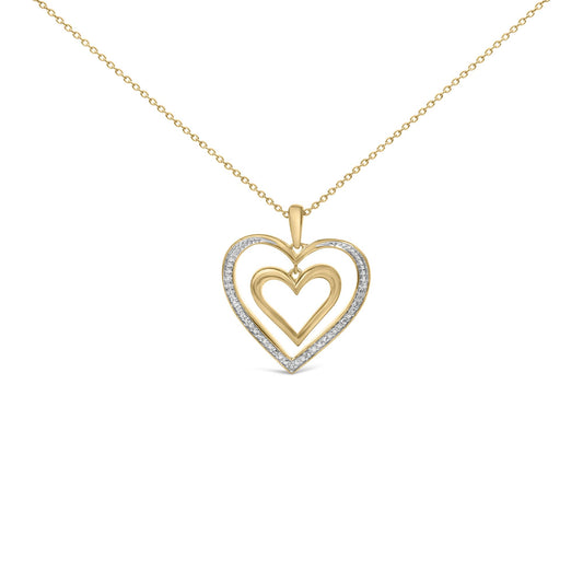 Close-up front angle of a yellow metal necklace with a heart-shaped pendant featuring two open heart designs, the outer heart accented with white gemstones in a pave setting.