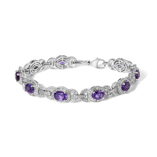 White metal bracelet with alternating oval purple gemstones and round white gemstones in pave setting, shown from a slightly angled top view.