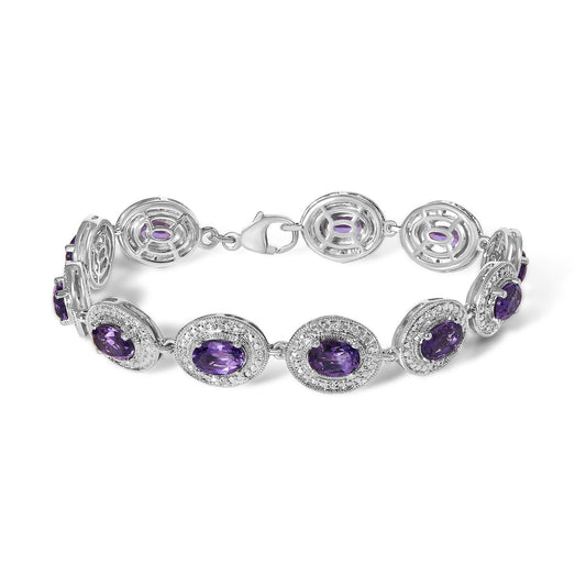 White bracelet shown from a top angle with oval purple gemstones surrounded by small white gemstones in prong settings.