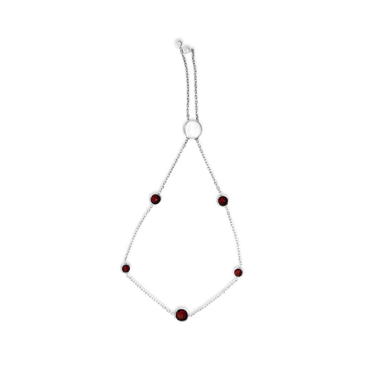 White bracelet with multiple round red gemstones in bezel settings, shown flat on a white background from a top-down angle.