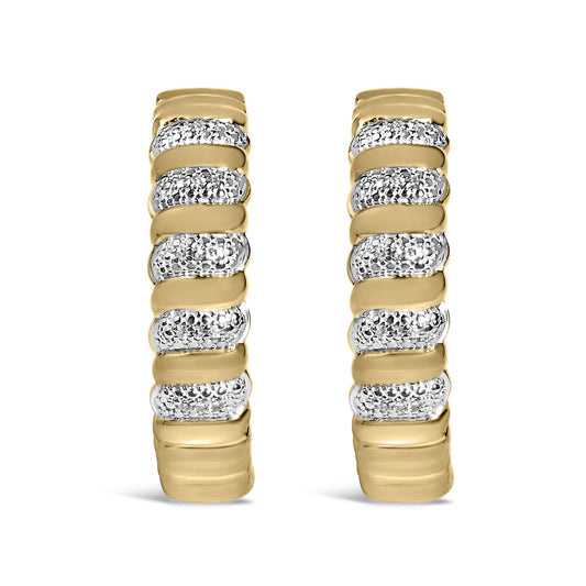 Close-up front view of a pair of yellow metal earrings featuring alternating smooth bands and sections paved with round white gemstones.