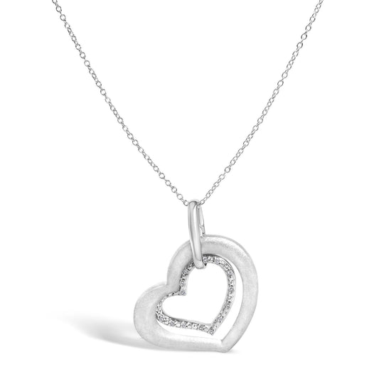 Close-up front angle of a white necklace with a double heart pendant, the inner heart outlined with small white gemstones in prong settings.