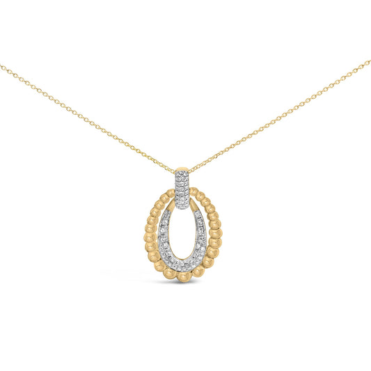 Close-up front view of a yellow metal necklace with an oval pendant featuring round white gemstones in a pave setting along the center and top, bordered by textured yellow metal beading.