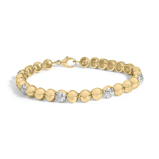 Close-up image of a yellow metal bracelet with round links, each featuring clusters of white gemstones in pave setting, shown flat on a white background from a top-down angle.
