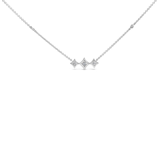Front view of a white metal necklace with three connected princess shape settings each holding a white gemstone, attached to a delicate chain with two round bezel set white gemstones along the chain.