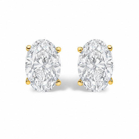 Close-up front view of a pair of oval-shaped white gemstone earrings in four-prong yellow metal settings on a white background.