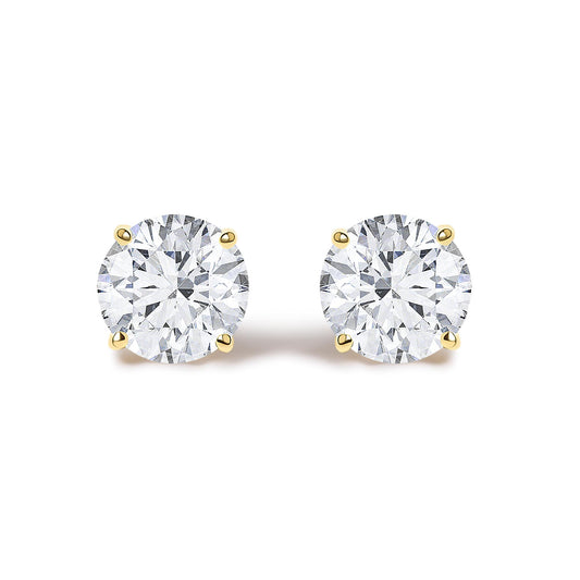 Close-up front angle of a pair of round white gemstone stud earrings set in yellow metal with four prongs, shown on a white background.