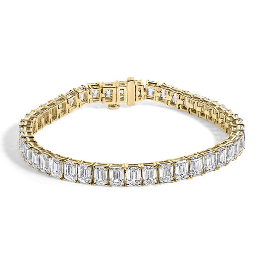 Yellow bracelet with emerald-shaped white gemstones in four-prong setting shown in a front angle view on a white background.