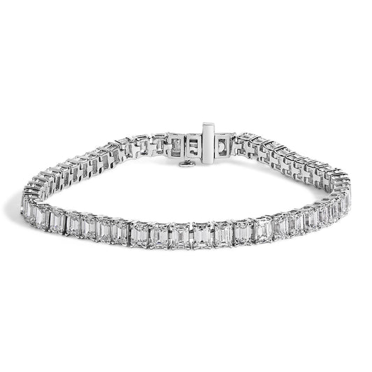 White metal bracelet with emerald-shaped white gemstones in 4-prong settings, displayed flat on a white background, shown from a slight top-front angle.
