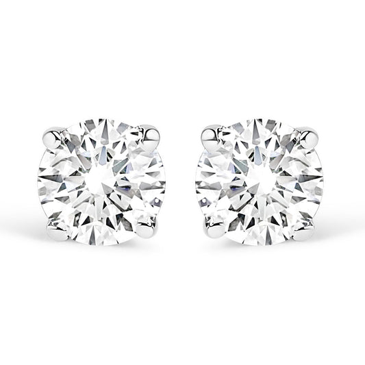 Close-up front view of a pair of white metal stud earrings, each featuring a round white gemstone in a four-prong setting.