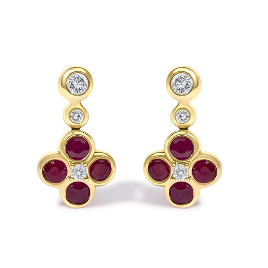 Front view of yellow metal earrings with a round white gemstone at the top, followed by a smaller round white gemstone, and a cluster of red round gemstones surrounding a central white gemstone.