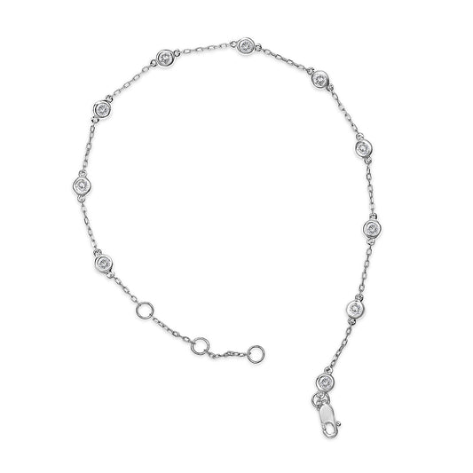 White metal bracelet with small round white gemstones in prong settings, shown flat from a top-down angle.