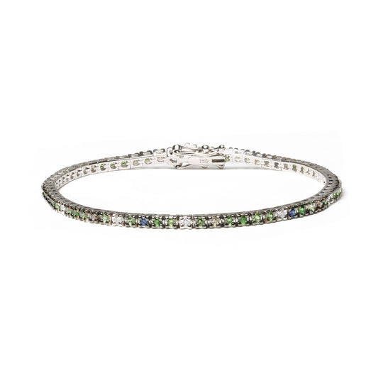 White metal bracelet with prong-set green, blue, brown, and white round gemstones, shown from a front angle on a white background.