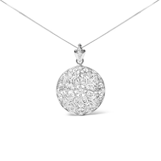Front-facing shot of a round white metal brooch with intricate floral filigree design, accented with multiple round white gemstones in bezel settings.