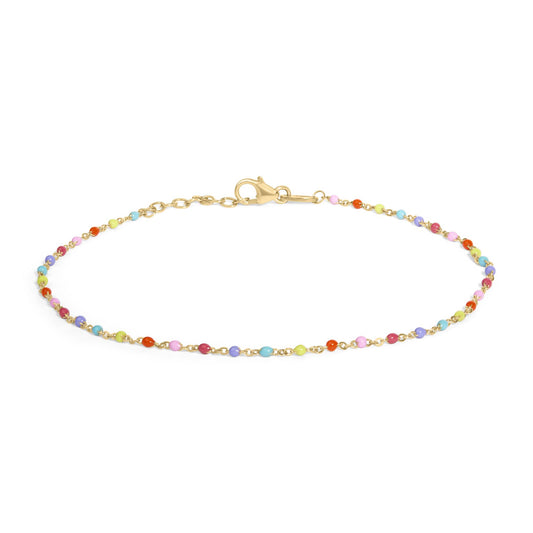 Close-up front view of a yellow metal bracelet with a lobster clasp, featuring small multicolored round gemstones evenly spaced along the chain, shown on a white background.