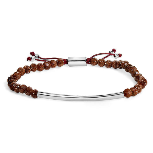 White metal bracelet with faceted brown gemstones and a curved metal bar, shown in a front flat lay angle.