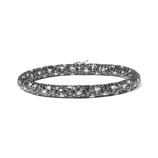 White metal bracelet with round black and white gemstones in prong setting, circular shape, shown on a white background from a front angle.