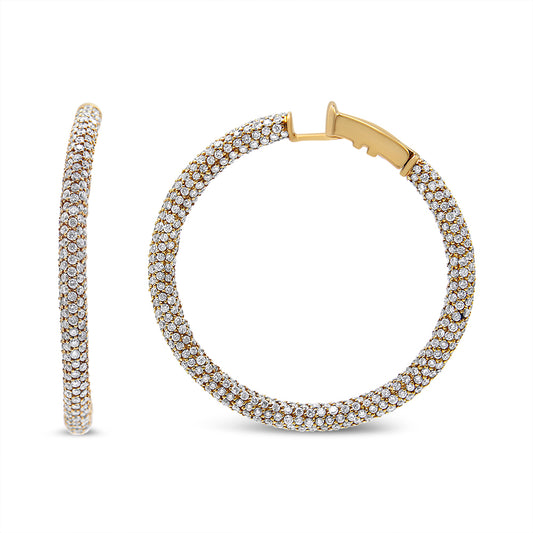 Close-up front and side view of round hoop earrings in rose metal, paved with white round gemstones.