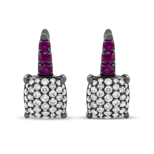Front view of white metal earrings featuring a square cluster of round white gemstones set in prongs and a top section with three round red gemstones in prong settings.