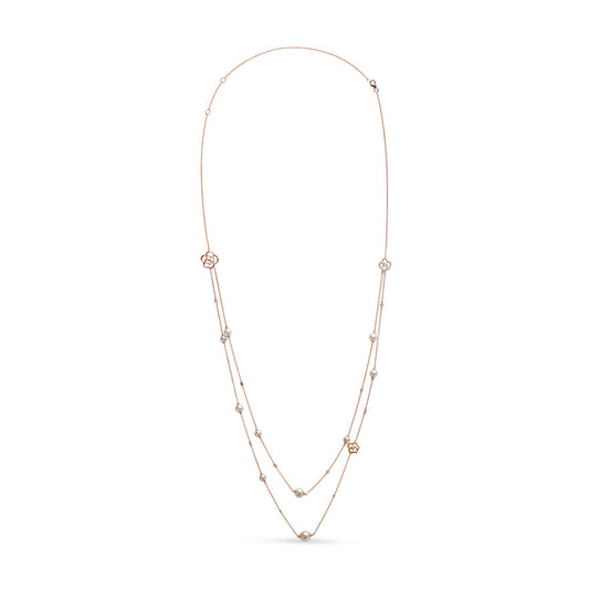 Front view of a long rose metal necklace with two strands, decorated with white round bezel-set gemstones and floral-shaped accents.